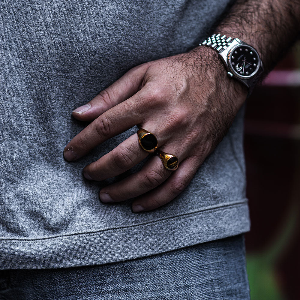 Title: A Glimpse into the Fashion World: A man wearing a ring and a tie