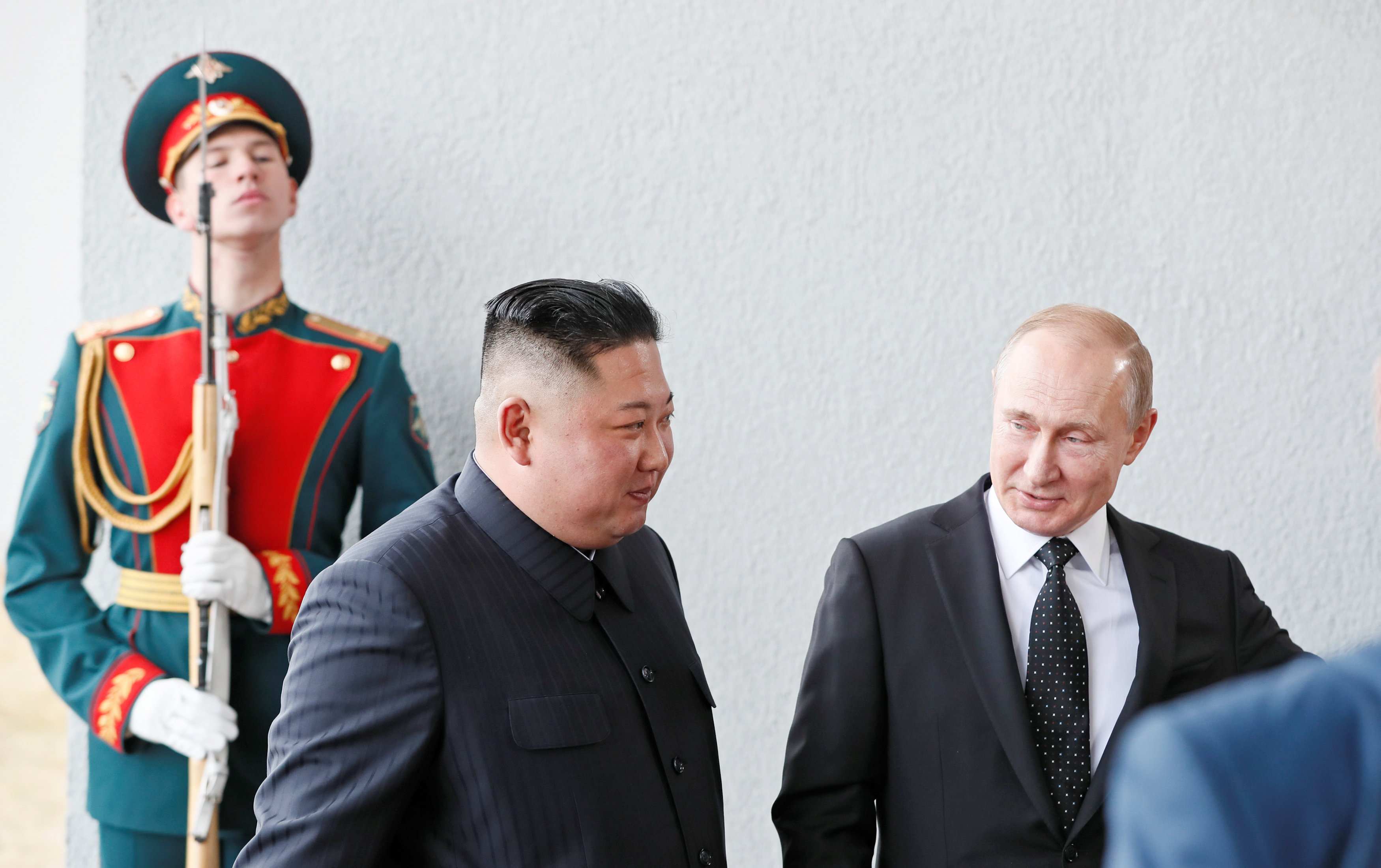Title: Putins Polite Gesture of Tidying His Tie